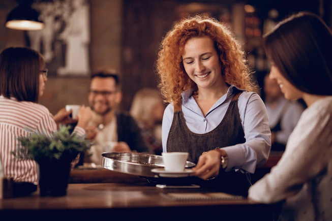 Woman enjoying coffee at Brew & Bean cafe
