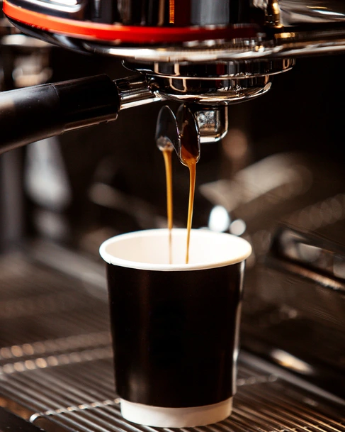 Barista preparing coffee behind the counter